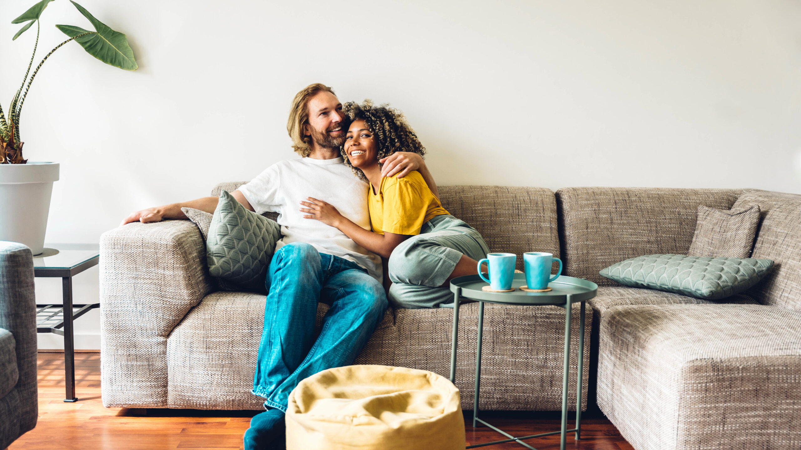 younger couple relaxing in living room